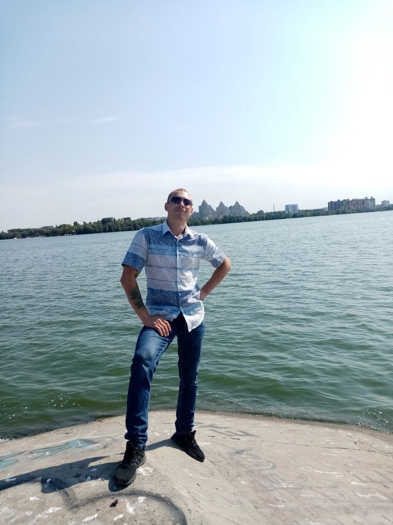 A person standing in an urban area with buildings in the background